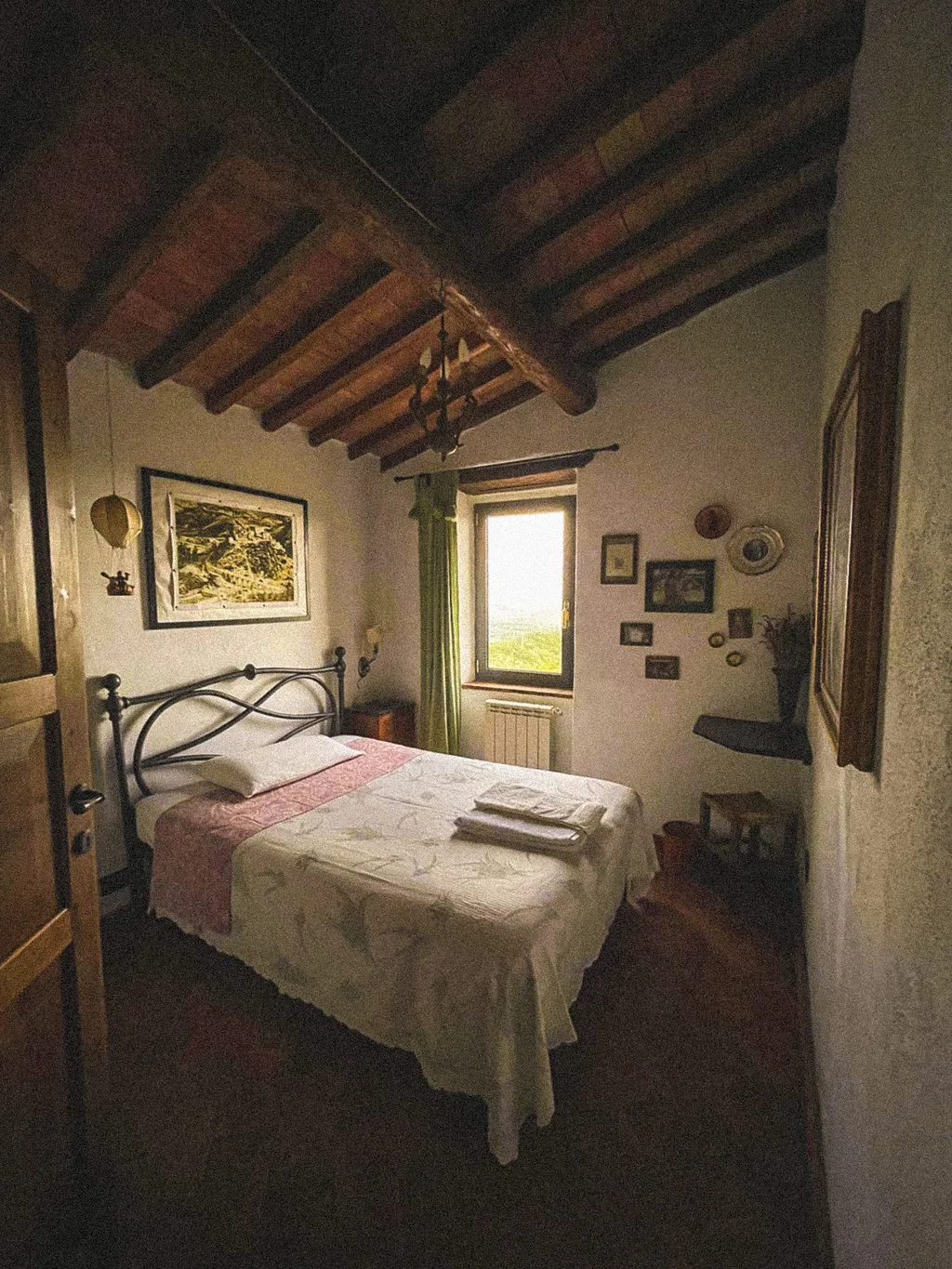 A bedroom with a wrought-iron bed