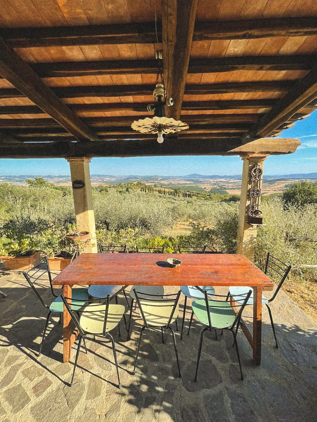 The table under the terrace, looking onto the olive grove and hills
